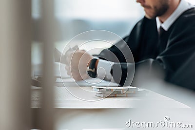 Focus of laptop near gavel and money near judge and money on table Stock Photo