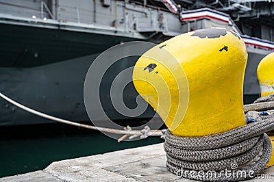 Selective focus on line securing a naval boat to a port bollard. Stock Photo