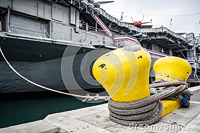 Selective focus on line securing a naval boat to a port bollard. Stock Photo