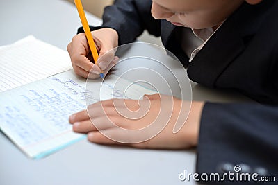 Selective focus of little boy learning how to write his name, Kid study at home, Children do homework at home, Concept for toddler Stock Photo