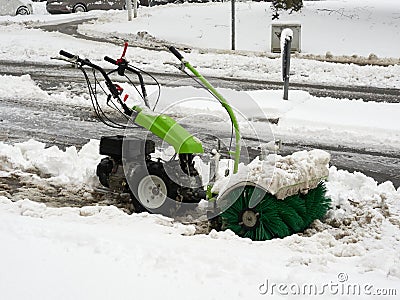 Selective focus. Machine for removing snow from pavements. Winter attack in Germany. Heavy snowfall in NRW in the Mettmann county. Stock Photo