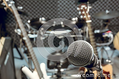 selective focus microphone and blur musical equipment guitar ,bass, drum piano background. Stock Photo