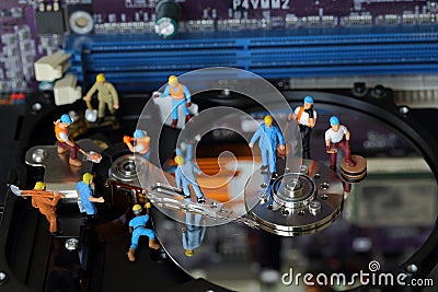 Selective focus of miniature engineer and worker maintenance hard disk and fixed problem hard disk of Personal computer PC on Stock Photo