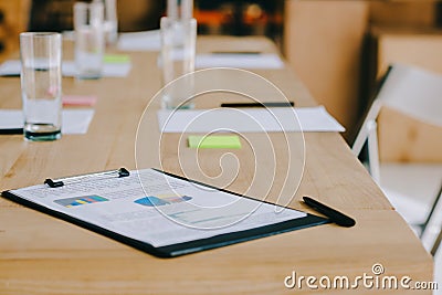selective focus of notepad, stationery and glasses of water at workplace Stock Photo
