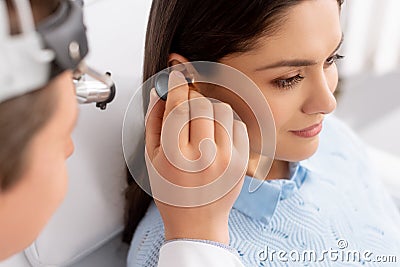 Focus of otolaryngologist examining ear of Stock Photo