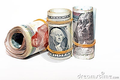 Pile of American dollars rolls with rolled up Egyptian money banknote bills of 100 LE, 200 LE Stock Photo