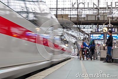 Cologne central railway station with blur background of motion of High speed train and group of passengers in Cologne, Germany. Editorial Stock Photo