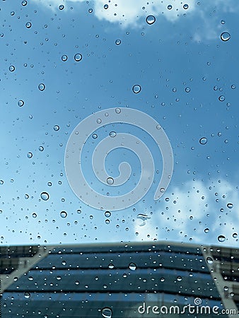 Scattered raindrops on the sunroof of a vehicle Stock Photo