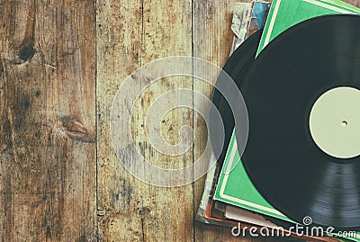 Selective focus of records stack with record on top over wooden table. vintage filtered Stock Photo