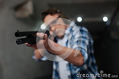 Selective focus of a rifle being in use Stock Photo