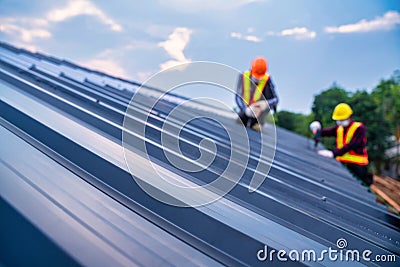 Selective focus roof, Roof concept of residential building under construction, Roofer worker safety wear using air or pneumatic Stock Photo