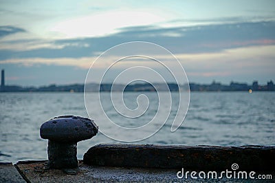 Selective focus of rusted steel post for seizing the ship at the pier Stock Photo