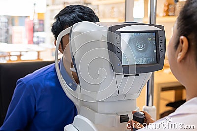 Selective focus at screen of Optometry equipment. While optometrist using subjective refraction to examine eye visual system of Stock Photo