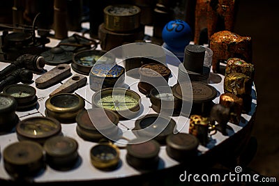 Selective focus shot of antique rare items collection including old compasses and elephant statues Stock Photo