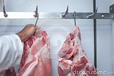 Selective focus shot of the butcher cutting a good piece of pork Stock Photo