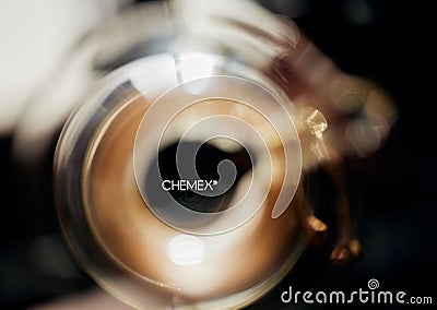 Selective focus shot of the Chemex logo seen through a glass coffee flask Editorial Stock Photo