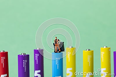 Selective focus shot of colorful batteries and a waste collector toy-energy preservation concept Stock Photo