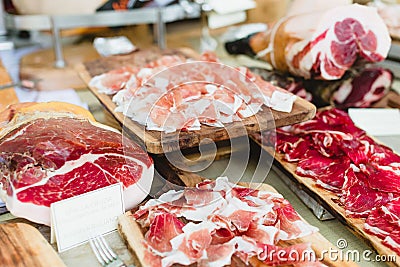 Selective focus shot of delicious ham served on wooden platters Stock Photo