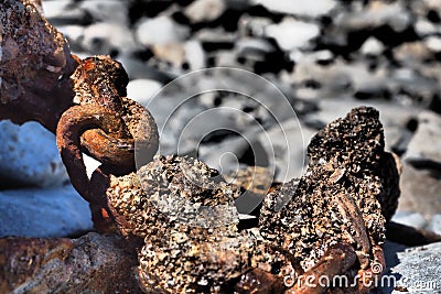 Selective focus shot of giant rusty chains in the sea Stock Photo