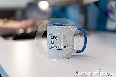 Selective focus shot of a mug with a printed text of CSS IS AWESOME with a blurred background Editorial Stock Photo