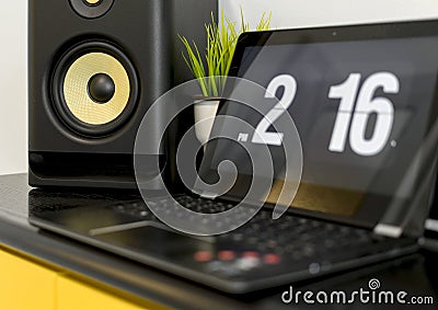 Selective focus shot of a music column, a flip clock screensaver showing the timecreen Stock Photo