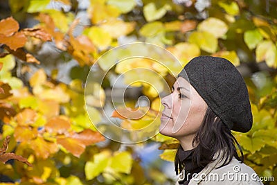 Selective focus shot of a pretty female with brown hat doing breath of fresh autumn air Stock Photo