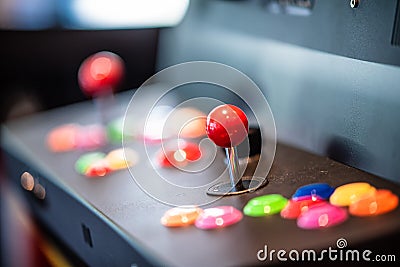 Selective focus shot of a red arcade joystick of a gaming machine in an office Stock Photo