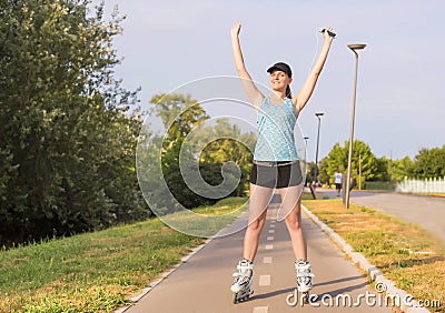 Selective focus shot of a young white female roller skating Stock Photo