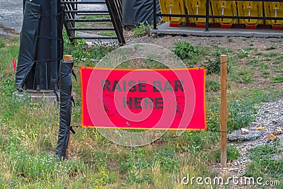 Selective focus of a sign in Park City with chairlift and trails at off season Stock Photo