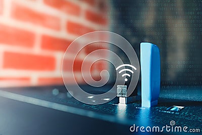 Selective focus of small portable WiFi router plugs into computer USB port to transmit and receive data securely. Concept: Stock Photo
