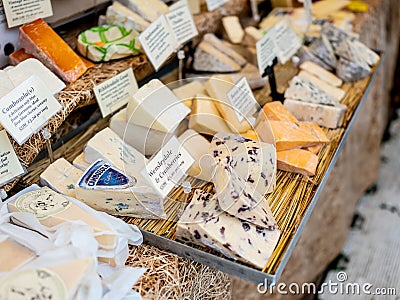 Close up of artisan and speciality cheeses for sale at a UK Christmas market Editorial Stock Photo