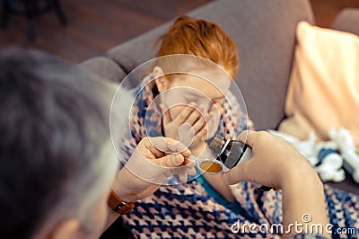 Selective focus of a spoon with cough mixture Stock Photo