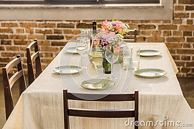 selective focus of table served with wine glasses, empty plates and bottle of wine Stock Photo