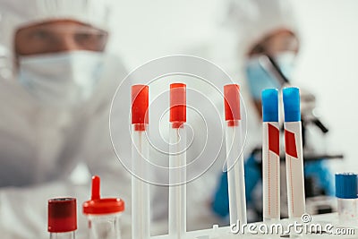 Selective focus of test tubes near biochemists Stock Photo