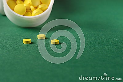 Selective focus on three yellow pills. Dose of vitamins to maintain immunity Stock Photo