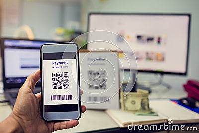 Selective focus to customer hand holding smart phone to scan Qr code payment Stock Photo