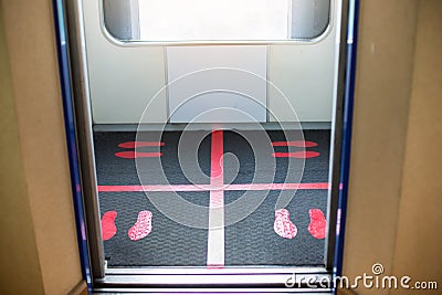 Selective focus to floor of passenger lift with standing marker for social distancing to avoid spreading coronavirus Covid-19 Stock Photo