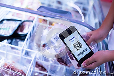 Selective focus to QR code tag on smartphone with blurry frozen food at supermarket Stock Photo