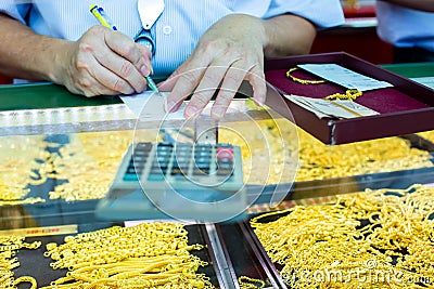 Selective focus to staff is writing sale order of gold jewelry in the gold shop Stock Photo