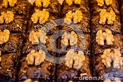 Selective focus of Turkish dessert with walnuts under the lights with a blurry background Stock Photo