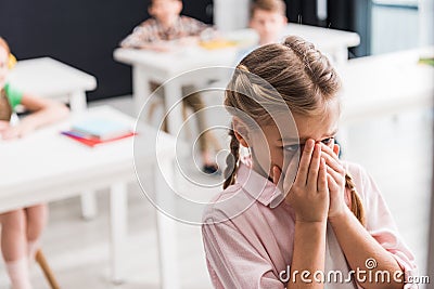 Selective focus of upset schoolkid crying Stock Photo