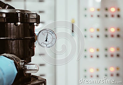 Selective focus at valve and gate measurement of big water pump / Background with light of electric panel Stock Photo