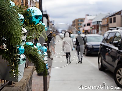 Selective focus view of Christmas exterior decorations of branches and large blue and silver balls Stock Photo