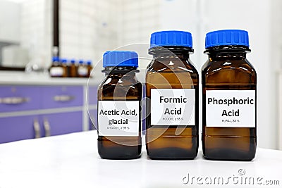 Selective focus of weak Formic, Acetic and Phosphoric acids in brown amber bottle. Stock Photo