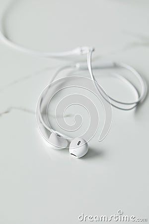 Selective focus of white earphones on Stock Photo