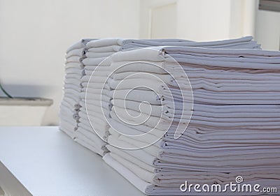 Selective focus of white folded sheets in a laundry Stock Photo
