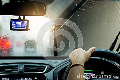 Selective focus of woman driving a car with rain droplet on wind Stock Photo