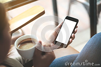 Selective focus woman hand holding phone sitting in coffee sh Stock Photo