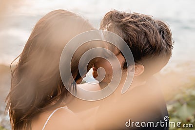 Selective focus of man kissing brunette Stock Photo