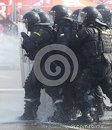 Selective of a group of policemen with shields during a riot Editorial Stock Photo